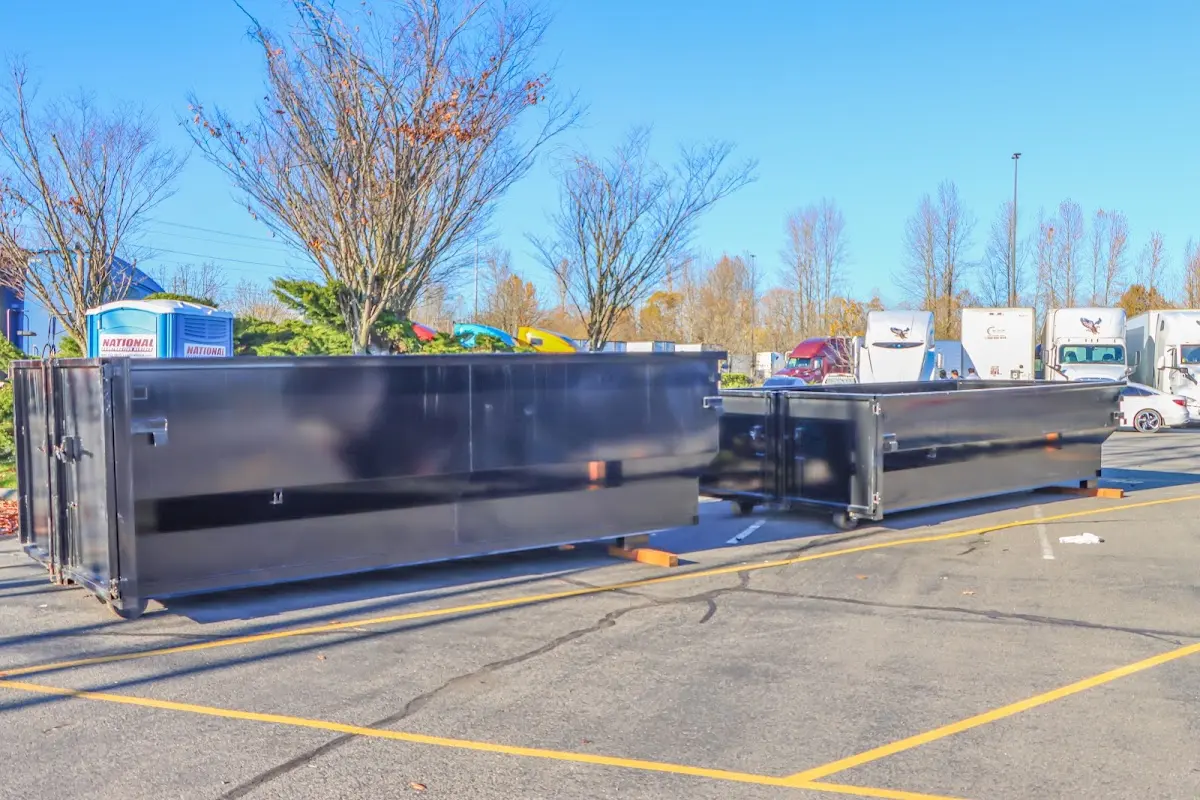Professional dumpster rental service with roll-off container on residential driveway in Vacaville